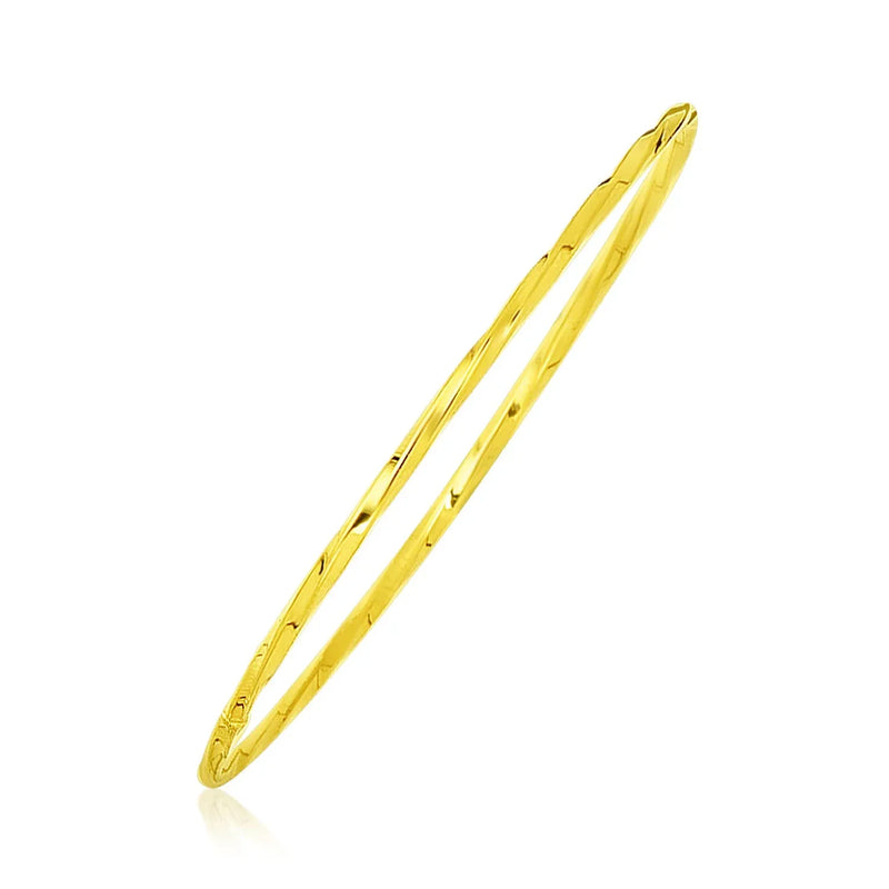 An image displaying 14k Yellow Gold Thin Twisted Shiny Bangle by Orca Market