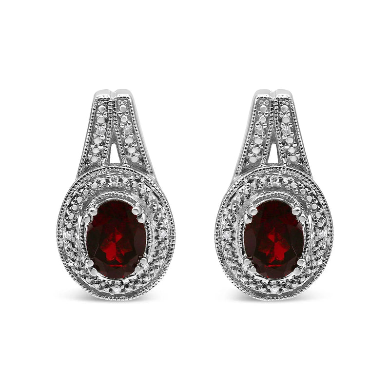 An image displaying .925 Sterling Silver Diamond Accent and 8x6mm Red Oval Garnet Stud Earrings (I-J Color, I1-I2 Clarity) by Infinite Jewels