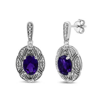 An image displaying .925 Sterling Silver Diamond Accent and 8x6mm Purple Oval Amethyst Stud Earrings (I-J Color, I1-I2 Clarity) by Infinite Jewels