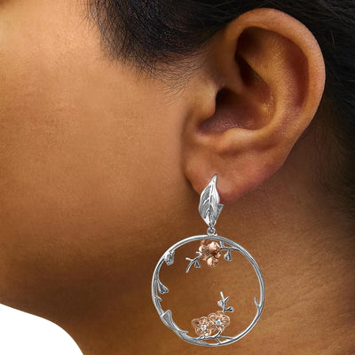 An image displaying Rose Gold Plated .925 Sterling Silver 1/10 Cttw Diamond Floral Hoop Earrings (I-J Color, SI1-SI2 Clarity) by Infinite Jewels