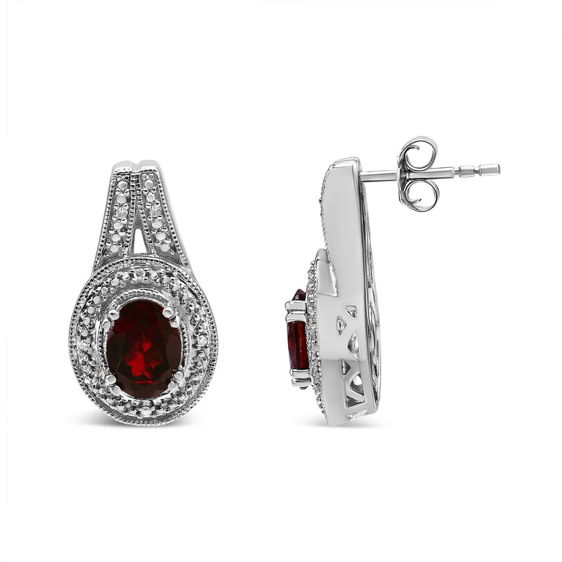 An image displaying .925 Sterling Silver Diamond Accent and 8x6mm Red Oval Garnet Stud Earrings (I-J Color, I1-I2 Clarity) by Infinite Jewels