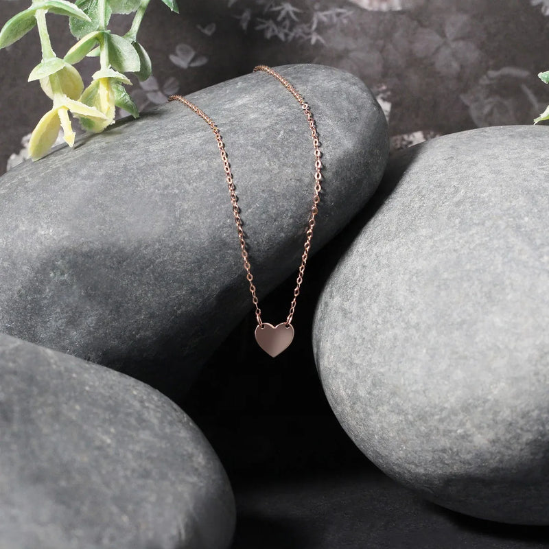 An image displaying 14k Rose Gold Polished Mini Heart Necklace by Orca Market