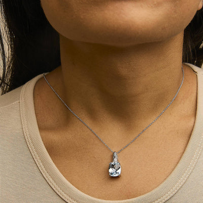An image displaying .925 Sterling Silver Blue Topaz and Diamond Accent Textured Pendant Necklace - 18" Inches by Infinite Jewels