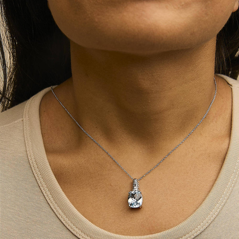 An image displaying .925 Sterling Silver Blue Topaz and Diamond Accent Textured Pendant Necklace - 18" Inches by Infinite Jewels