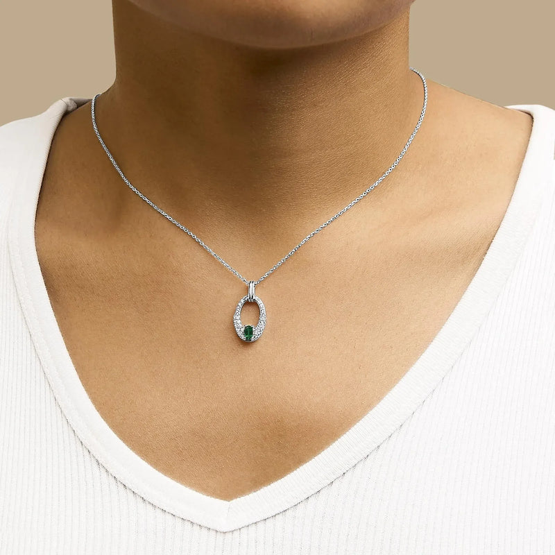 An image displaying .925 Sterling Silver Created Green Emerald and White Sapphire Oval Shaped Pendant Necklace - 18" Inches by Infinite Jewels