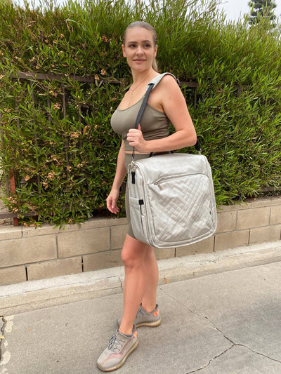 An image displaying Diaper Bag And Portable Foldable Changing Table by Bambini